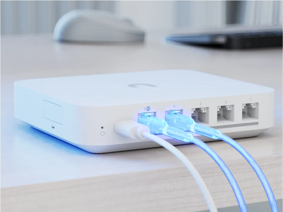 UniFi gateway rear with five numbered Ethernet ports and power connection